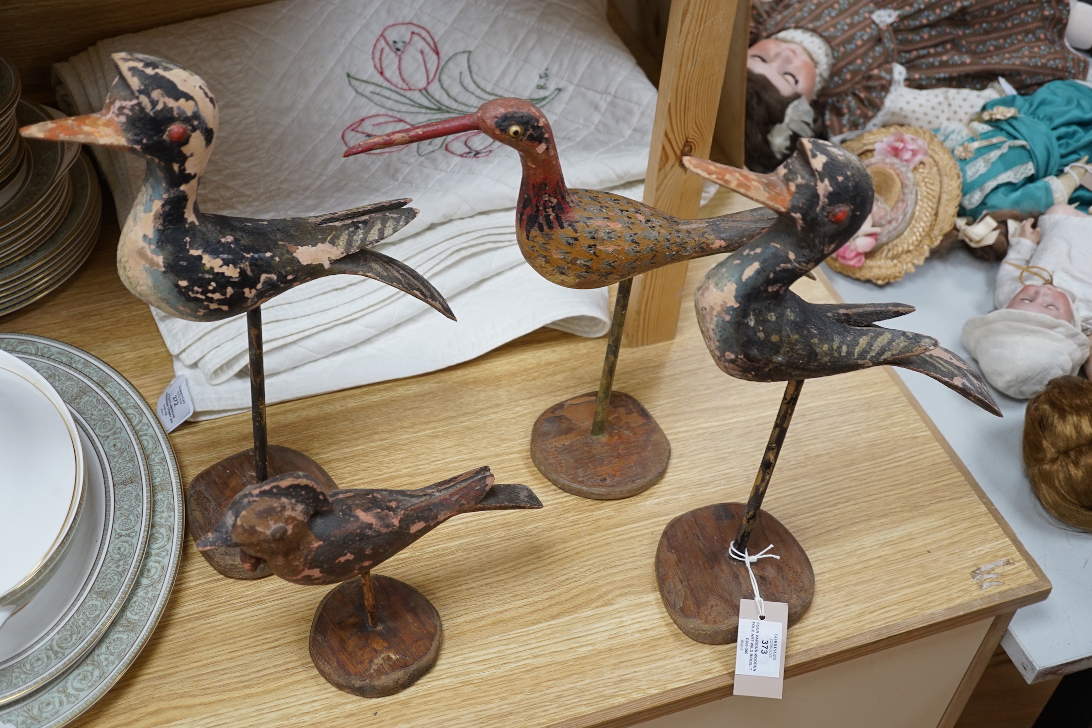 Four various wooden folk art wild birds. Tallest 43cm